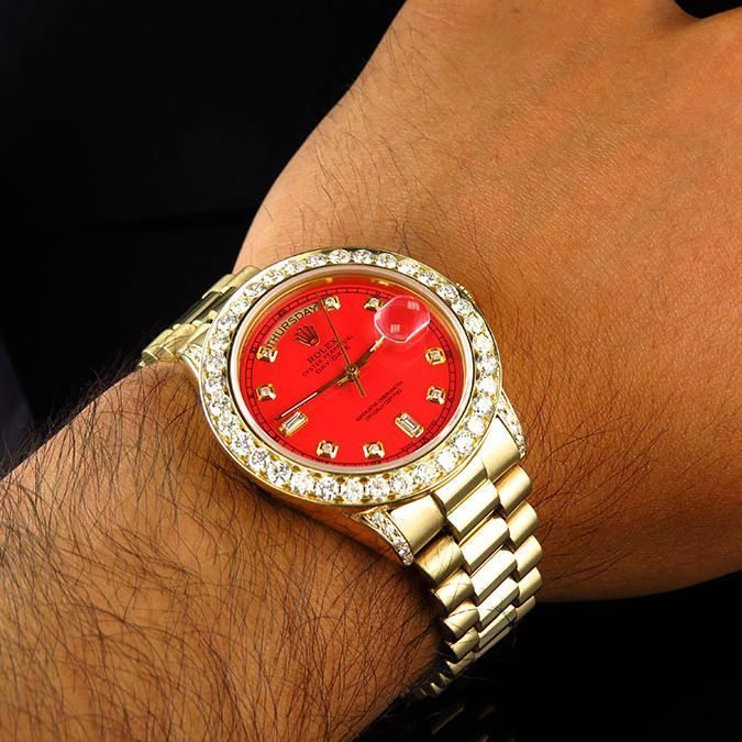 gold rolex with diamonds and red face